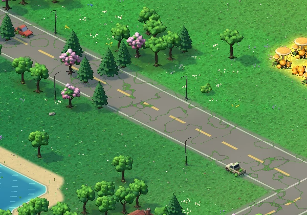 A cracked two-lane road running through meadow full of wildflowers, past quiet houses.